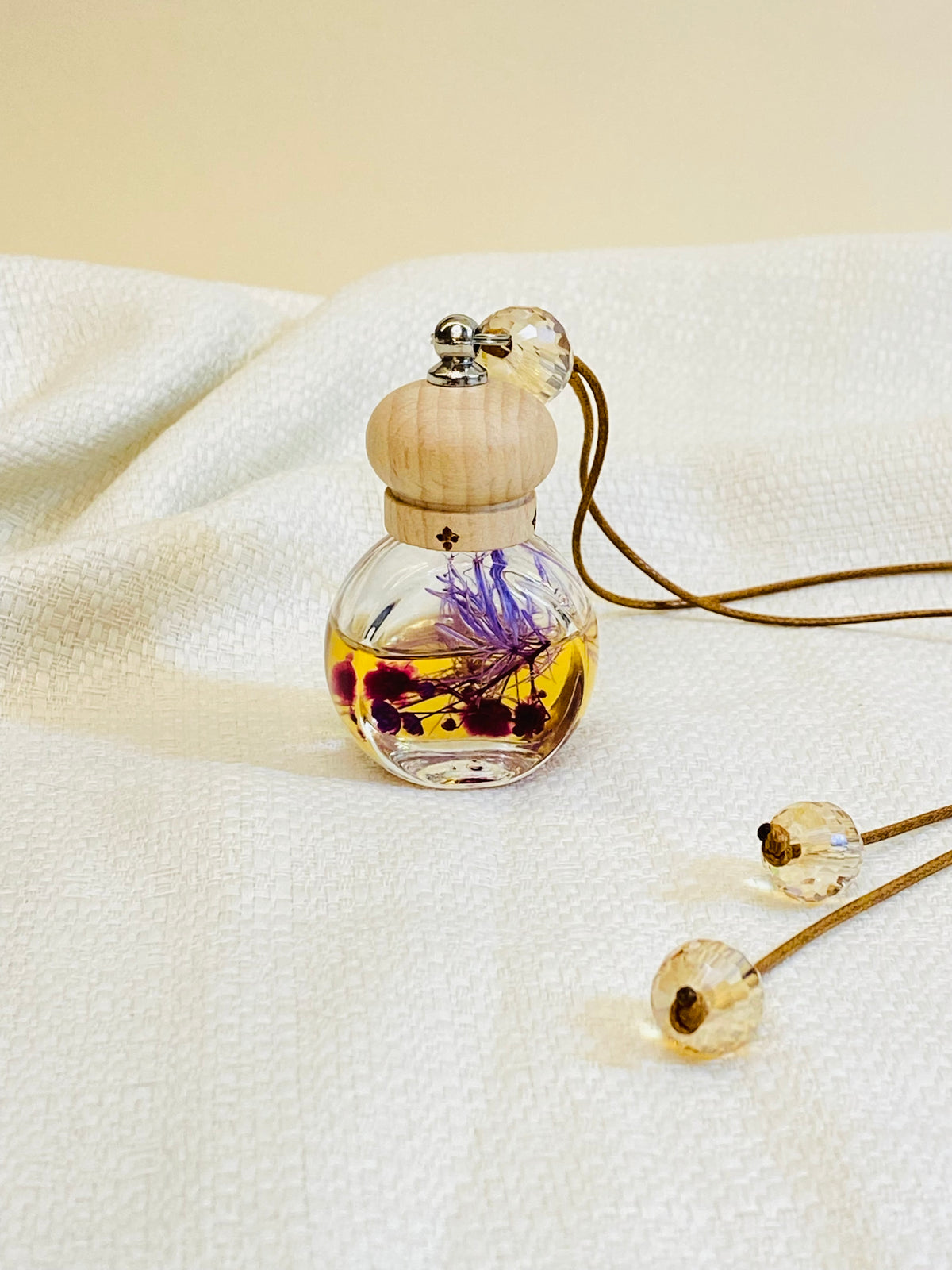 Glass bottle with wood lid, dried flowers inside