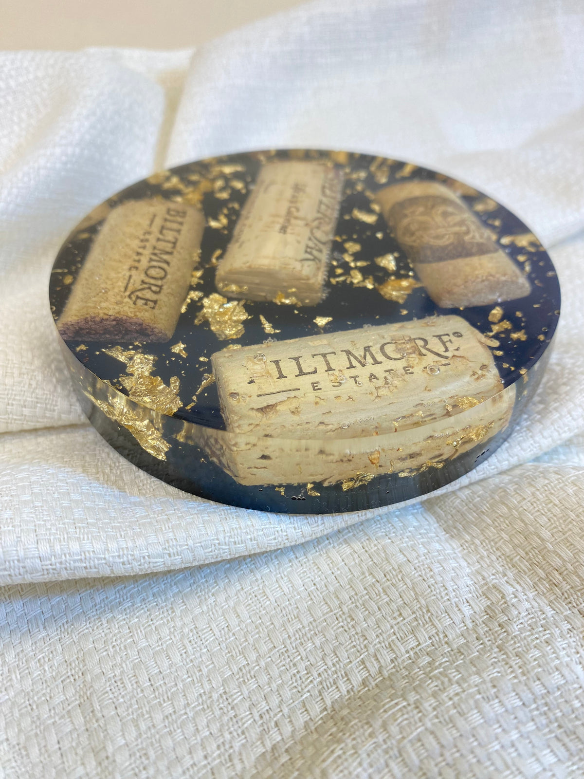 Handmade wine lover gifts Wine Cork Resin Coaster with gold leaf accents on a textured background.
