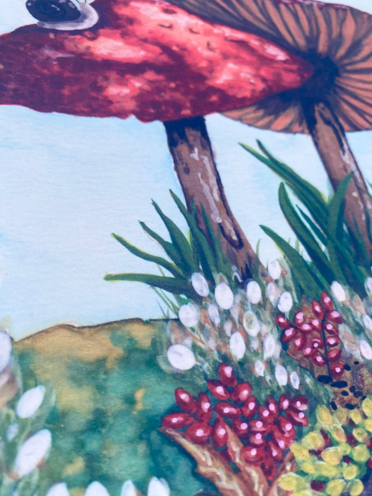 Close-up of mushroom stems, green leaves, and small white and red flowers in the art print.