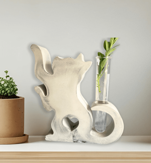Propagation cat vase made of hand-poured concrete, featuring a glass tube for nurturing plant cuttings.
