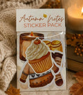 An 'Autumn Notes Sticker Pack' featuring illustrated autumn-themed stickers like a cupcake, pumpkin, cookies, and a sweater, shown in its packaging with a cozy fall background including a knitted blanket and a lit candle.