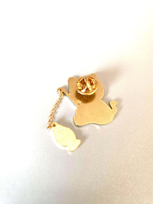 Adorable cat fishing enamel pin charm with gold details, perfect for jackets, hats, and purses.